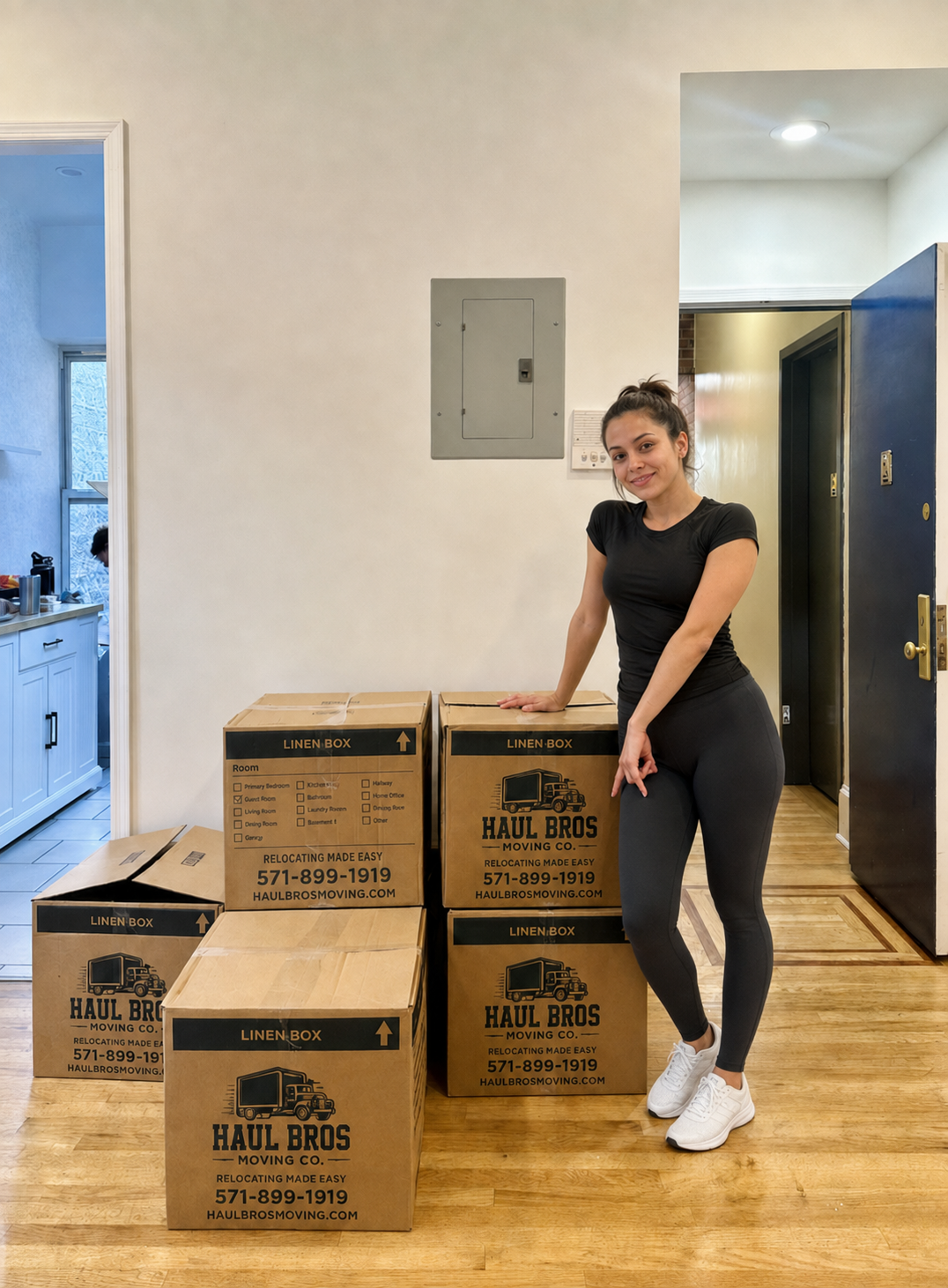 Woman standing beside Haul Bros moving boxes in a home