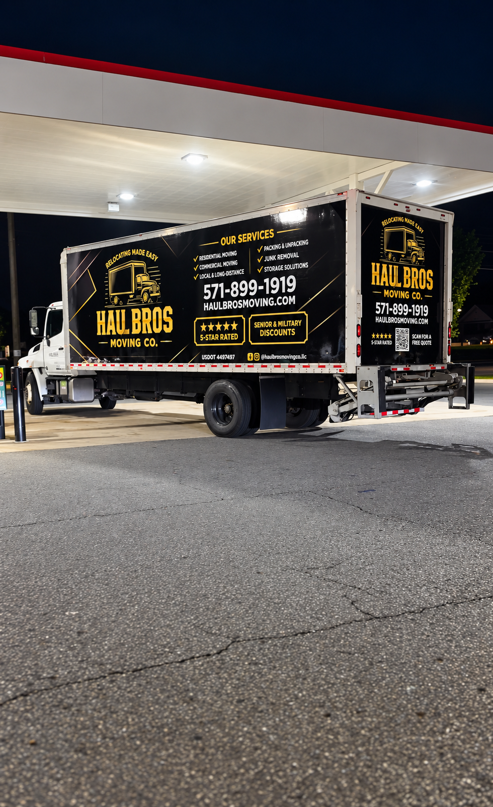 Haul Bros moving truck parked beneath an illuminated canopy at night