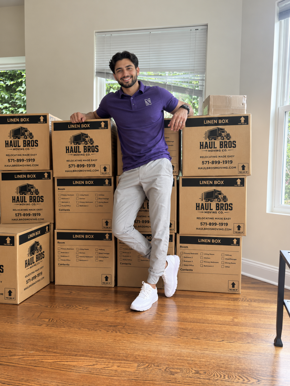 Man standing beside Haul Bros branded moving boxes inside a home