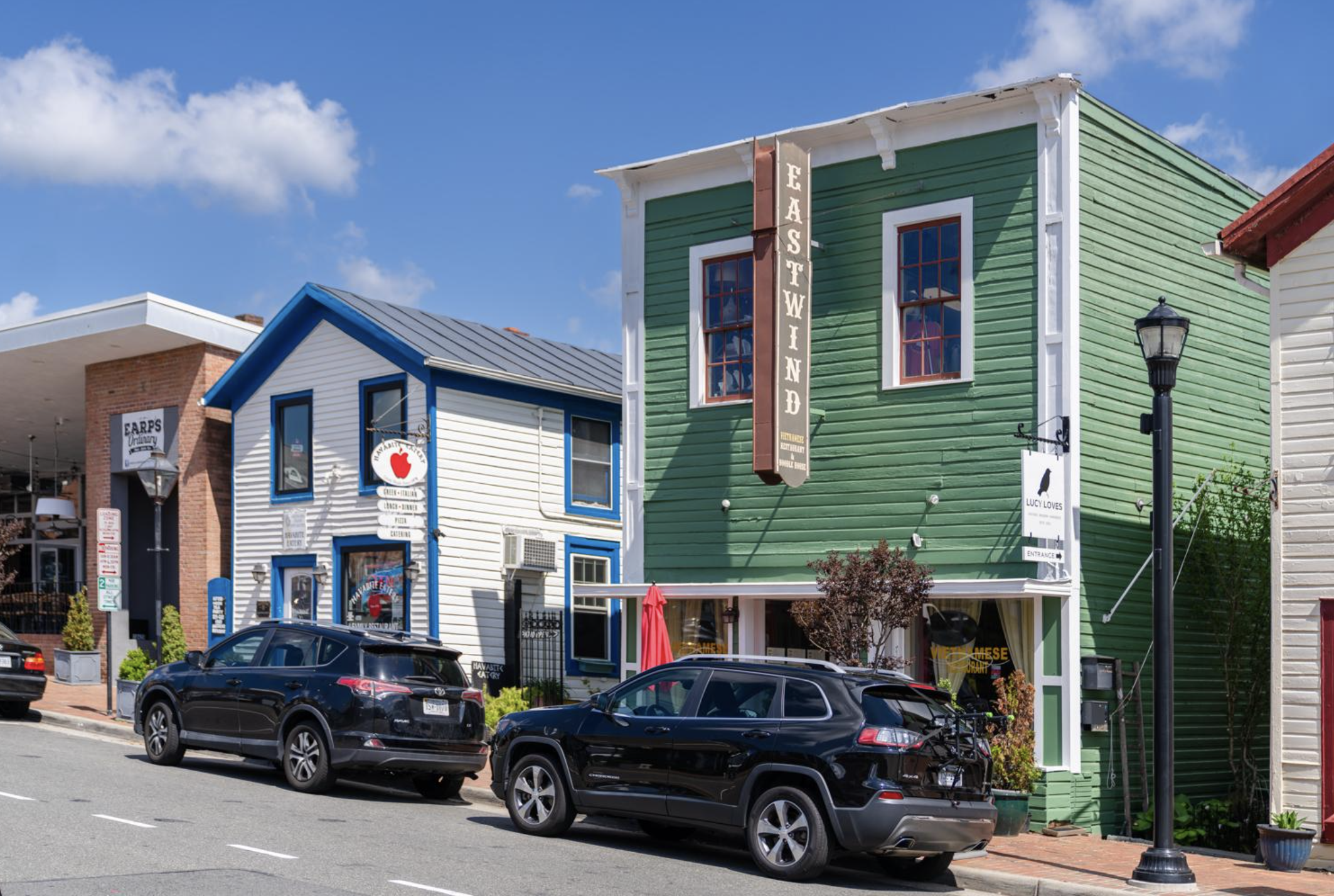 Colorful storefronts and parked cars in Old Town Fairfax
