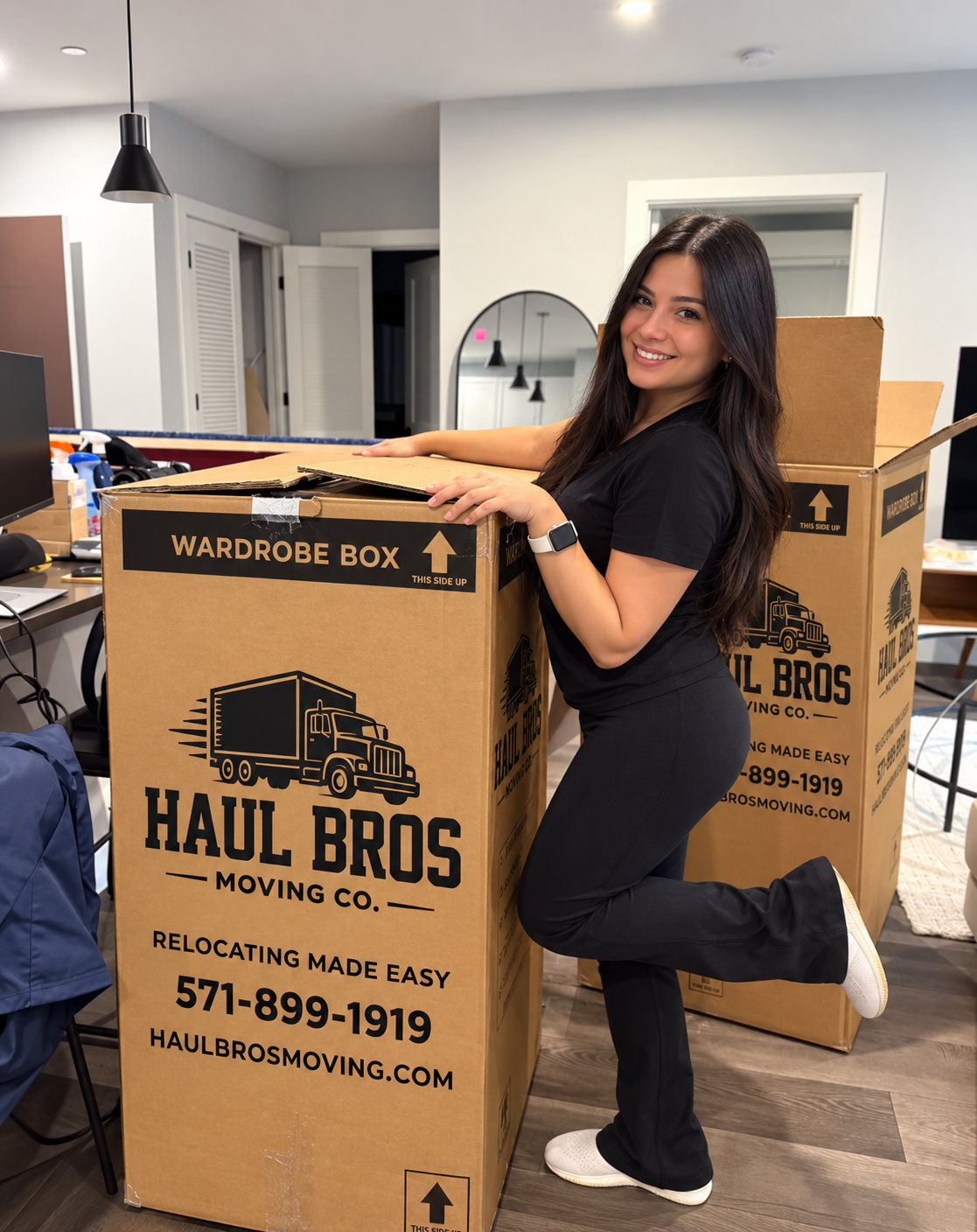 Woman smiling beside Haul Bros wardrobe boxes