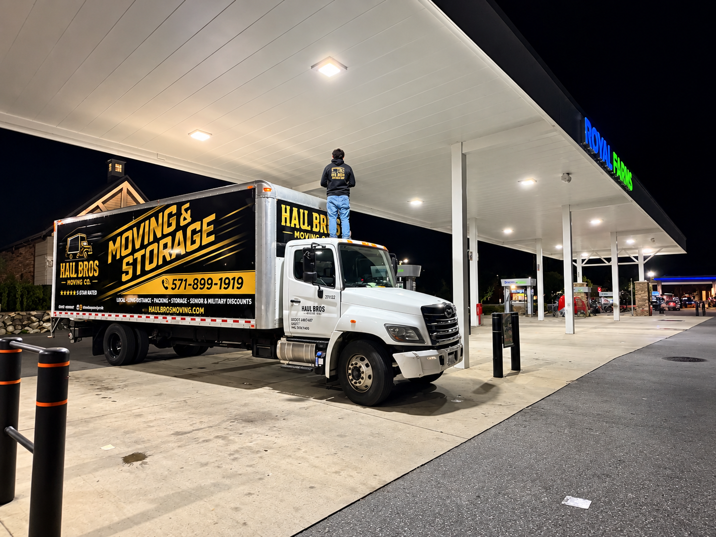 Haul Bros moving truck under Royal Farms lights at night