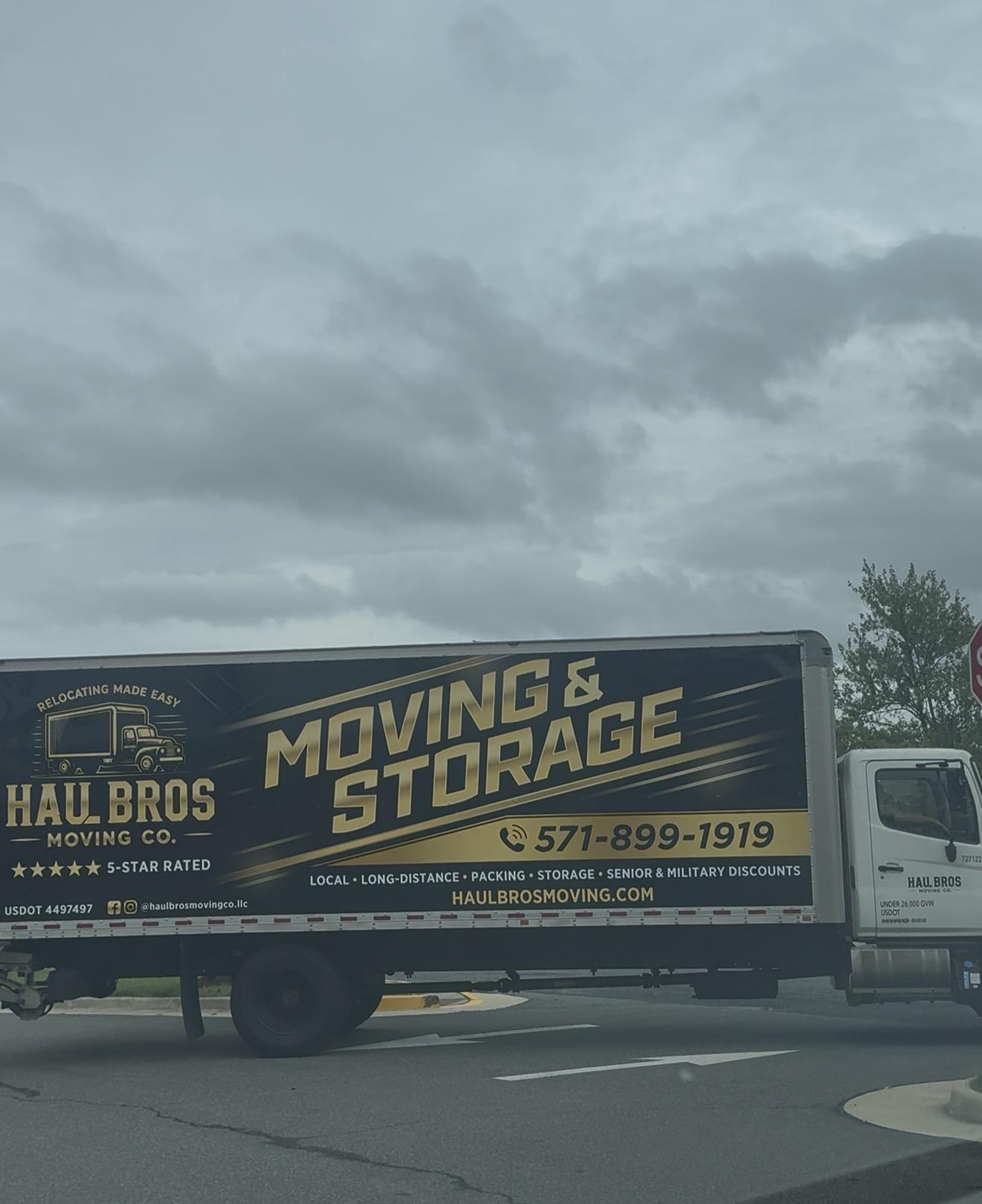 Haul Bros moving and storage truck near an intersection