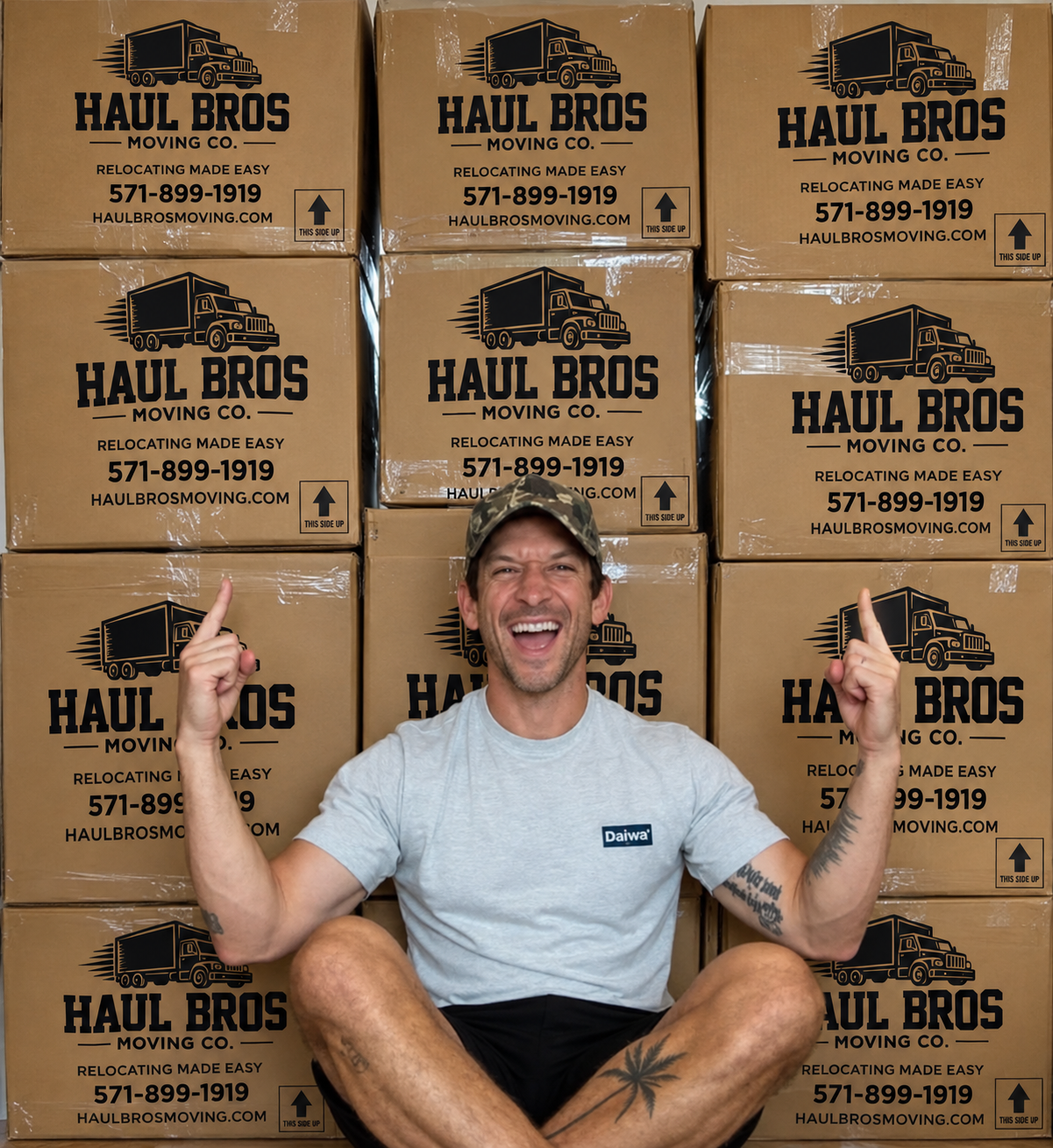 Man smiling in front of stacked Haul Bros moving boxes