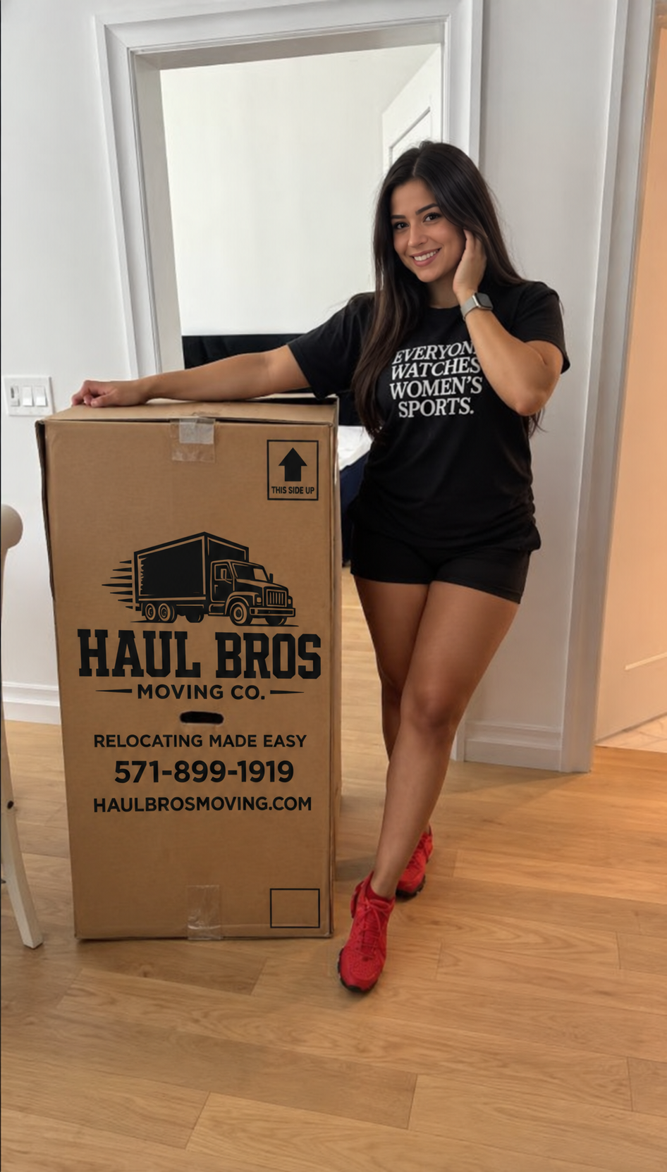 Woman smiling beside a Haul Bros moving box