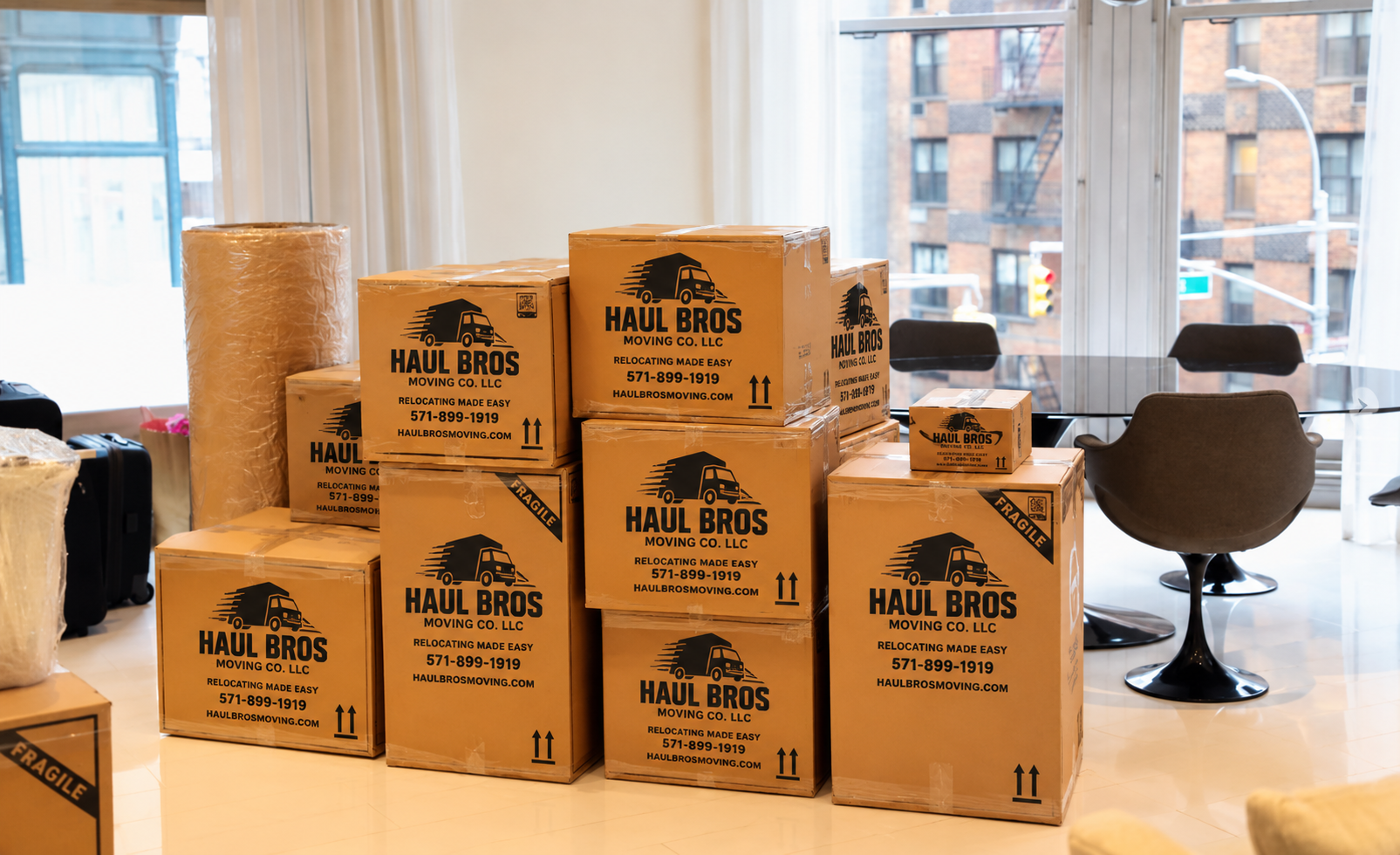 Haul Bros moving boxes and protective materials in a bright apartment