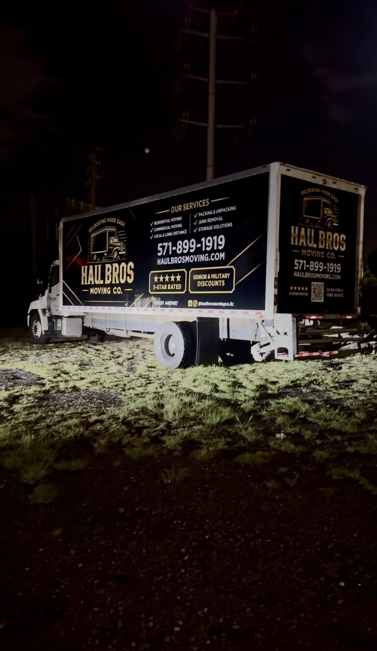 Haul Bros moving truck parked at night