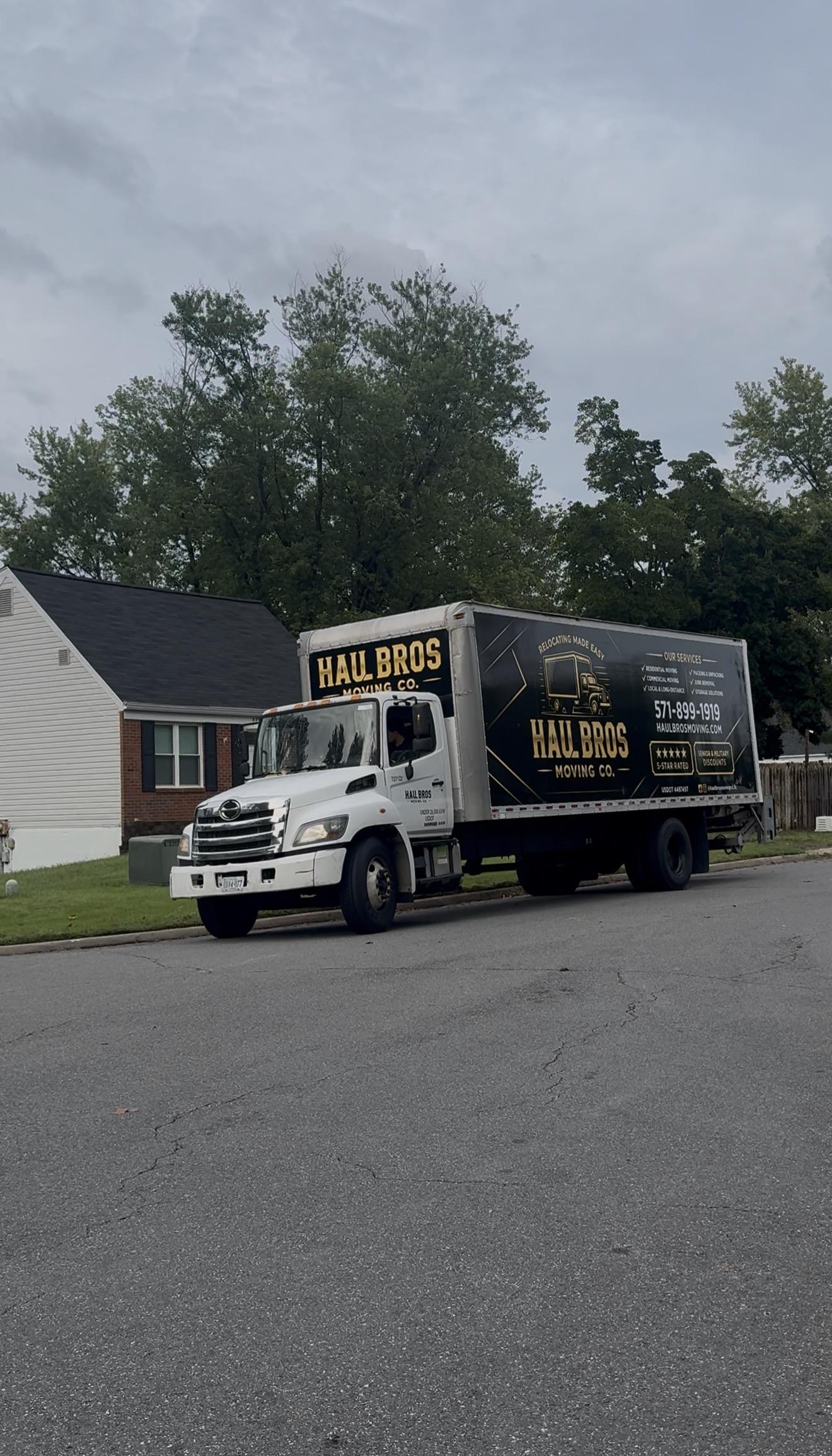 Haul Bros moving truck parked on a residential street